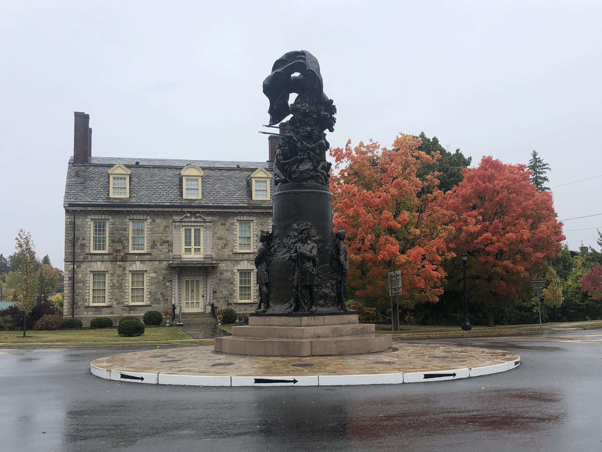 A large stone building and statue