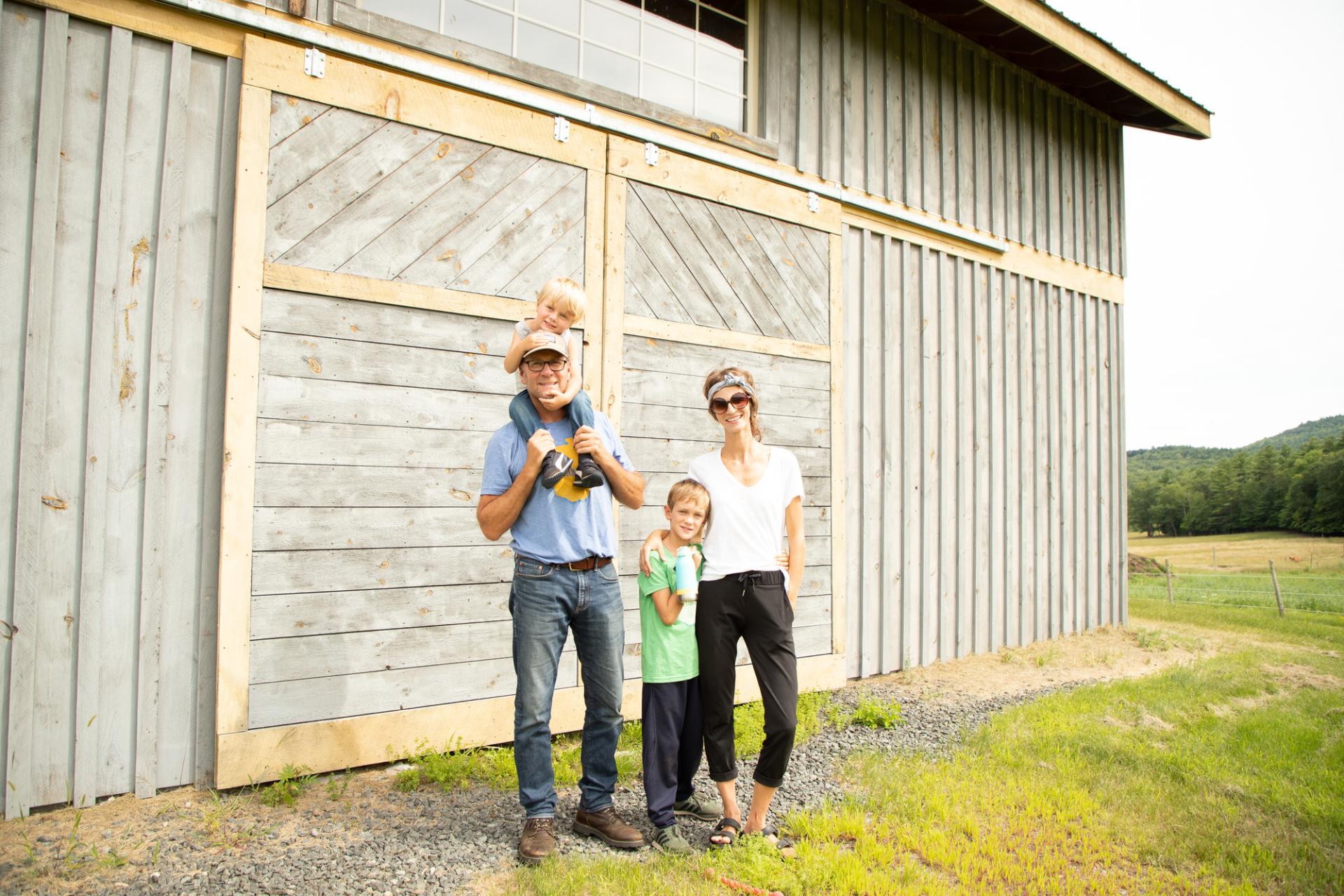 A family in front of a farm building