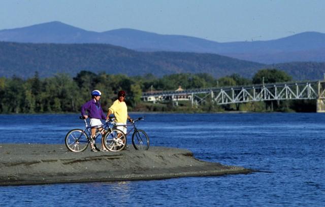 Cyclists viewing old Lake Champlain Bridge from afar