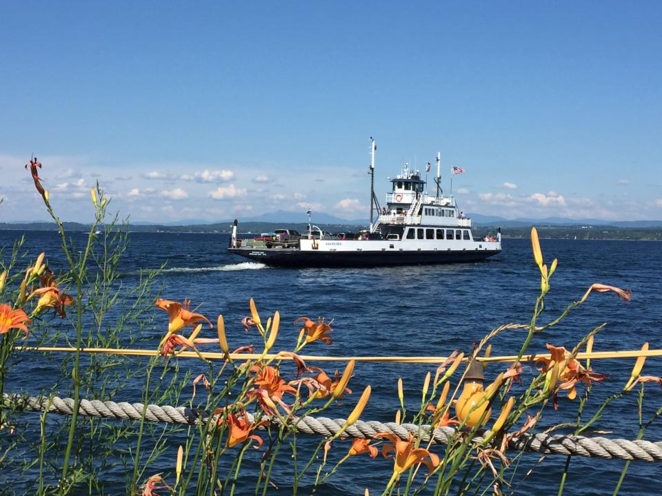Flowers and the Lake Champlain ferry. Vermont's mountains in the background.