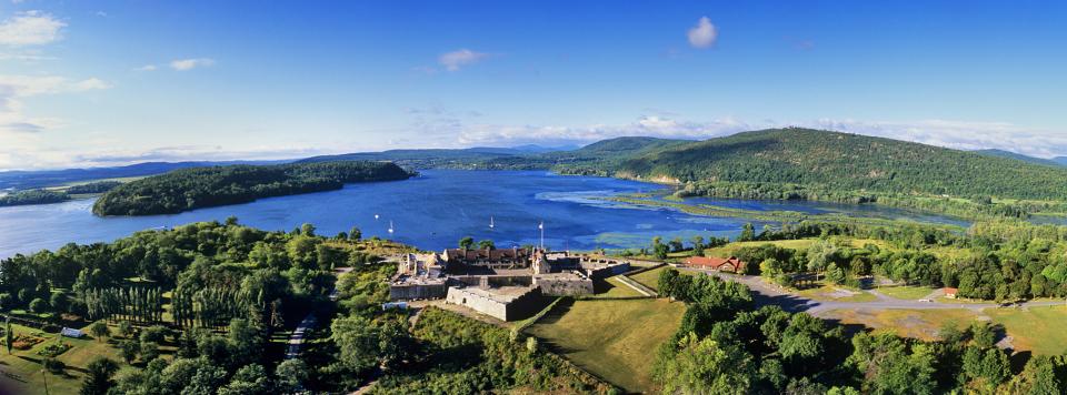 An aerial view in summer of the historic Fort Ticonderoga, with Lake Champlain beyond.