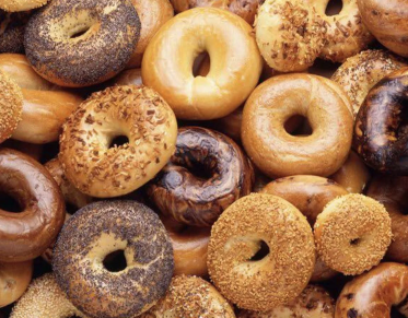 Bagels of various types in a delicious pile.