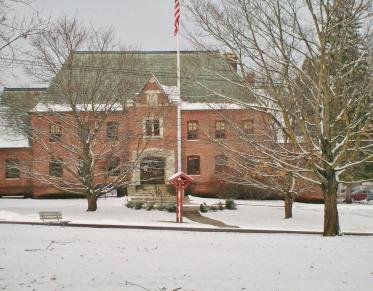 A large brick structure blanketed in fresh snow.