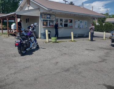 a snack bar in a parking lot on a sunny day. 
