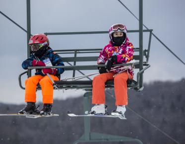 Two kids on a chair lift at Titus