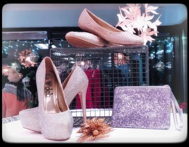 Shoes and purses in a display case.