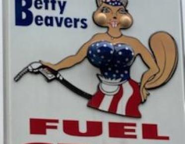 A large white sign with an illustrated beaver in a blue tube top and a white and red stripped skirt pumping gas.