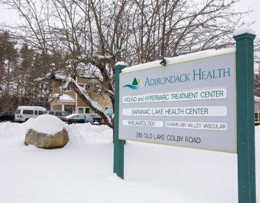 Entry sign with doctor names at the front of the Saranac Lake Health Center