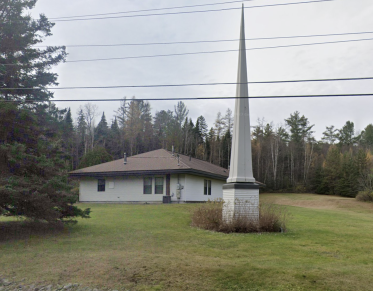 A white building with tall spire.
