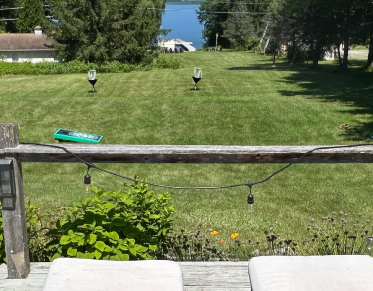 A sprawling lawn overlooking the water of Lake Champlain.