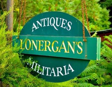 A green hanging sign reading Antiques Lonergan's Militaria