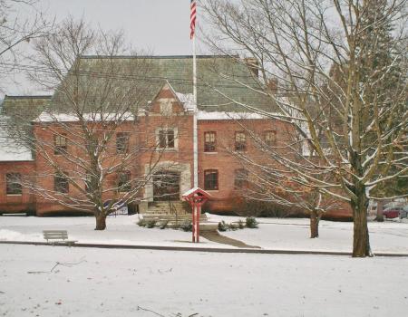 A large brick structure blanketed in fresh snow.