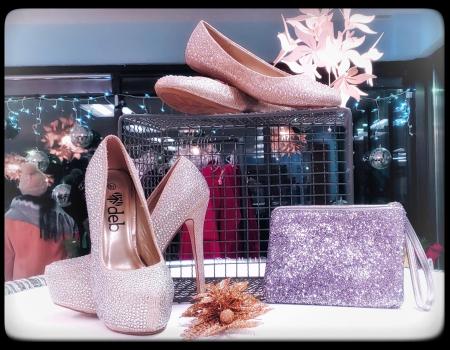 Shoes and purses in a display case.