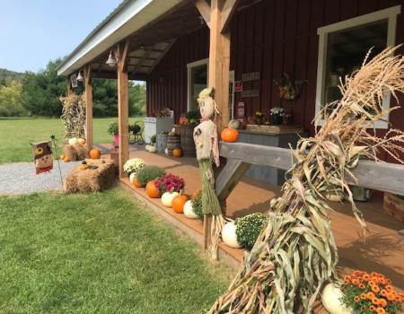 The covered porch decorated for fall