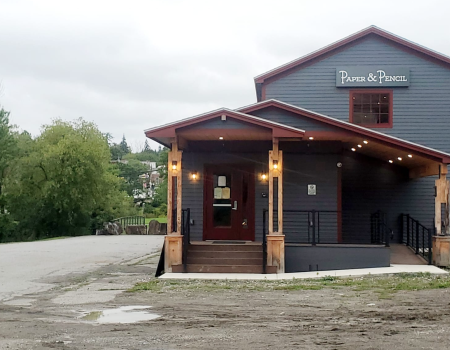 A blue building with a large covered entryway.