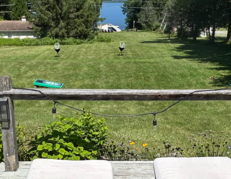 A sprawling lawn overlooking the water of Lake Champlain.