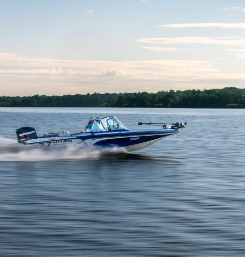 A boat gliding across Lake Champlain waters.
