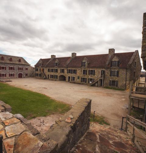 The center of a Revolutionary War fort surrounded by stone buildings. 