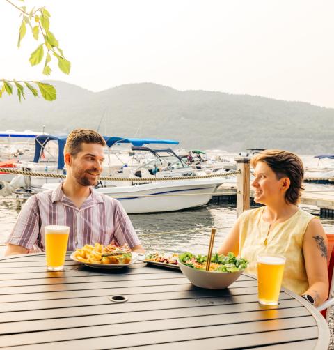 A couple dining lakeside near Lake Champlain.