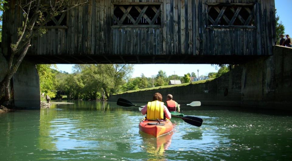 Paddle under historic bridges on the La Chute River.