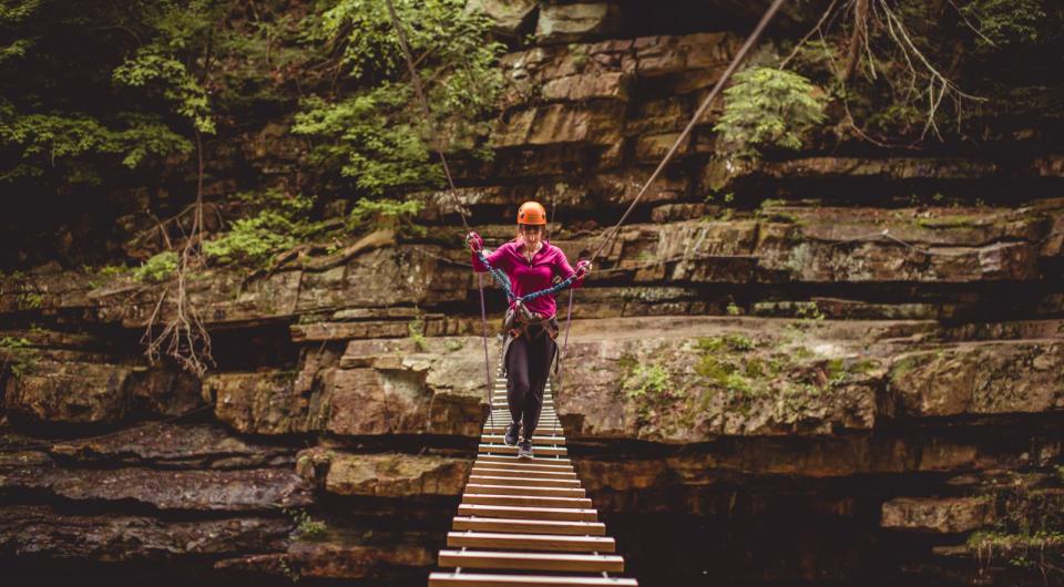 Take a daring walk across a wooden bridge to give unique perspective on the chasm