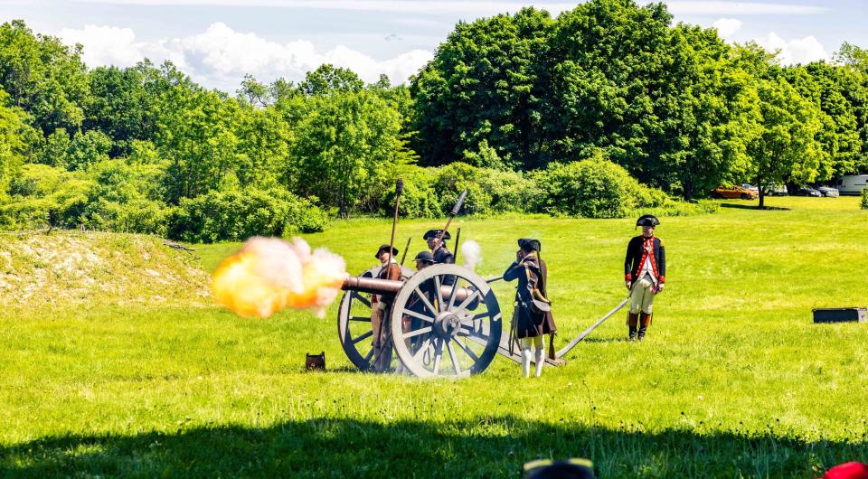 A cannon firing from the wall of the battlements