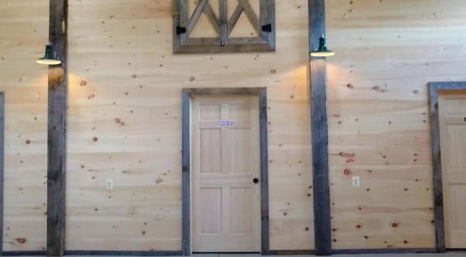 dark trim around the door of the storage room in the barn.