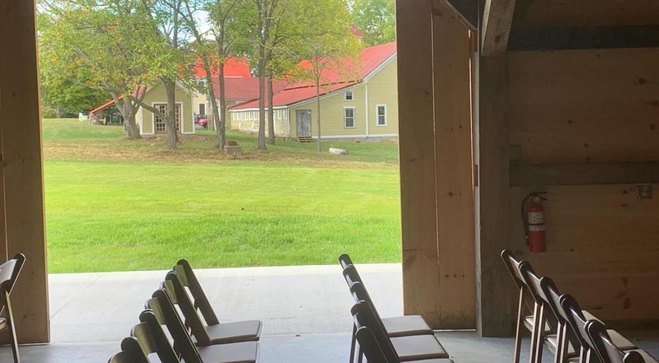 The doors of the barn rolled open to show the large grassy yard.