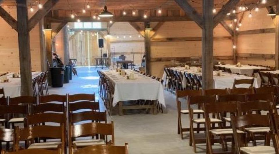 Backed up view of the tables set with white linens