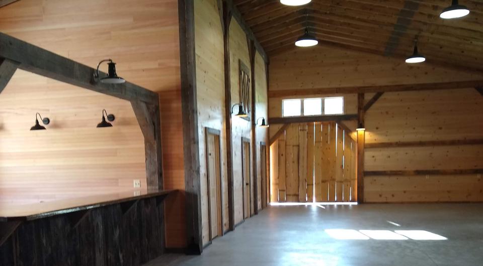 Tall ceiling of the barn by some storage rooms.