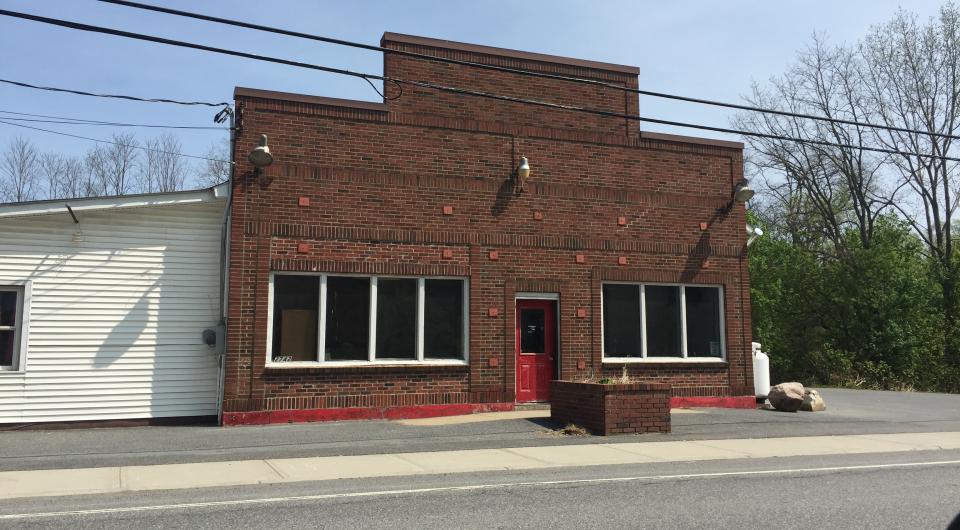 A tall and ornately arranged brick building.