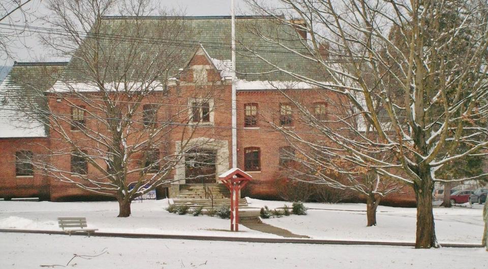 A large brick structure blanketed in fresh snow.