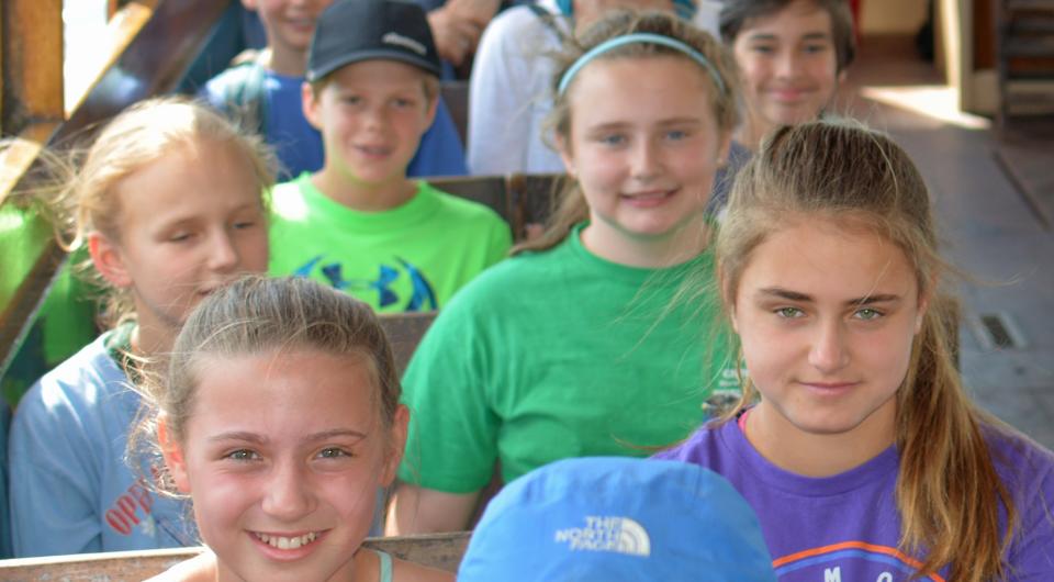 Students smile from their seats on the Carillon Boat Cruise