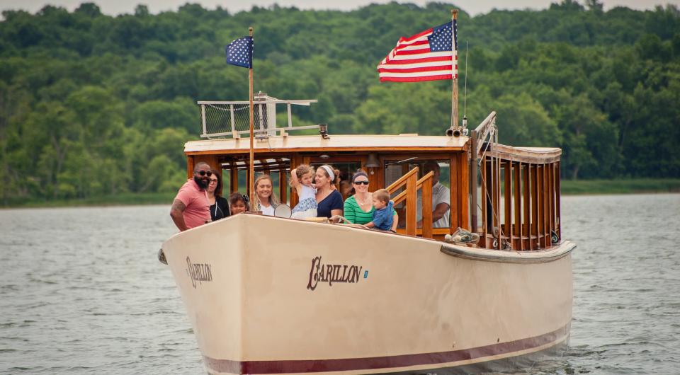People stand on the bow of the Carillon during their cruise.