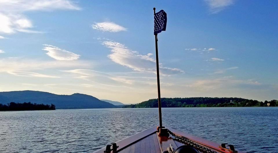 A view from the bow of the Carillon looking out over the waters of Lake Champlain and the surrounding mountains.