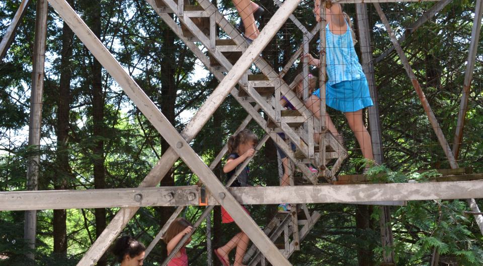 People climbing a fire tower steps.