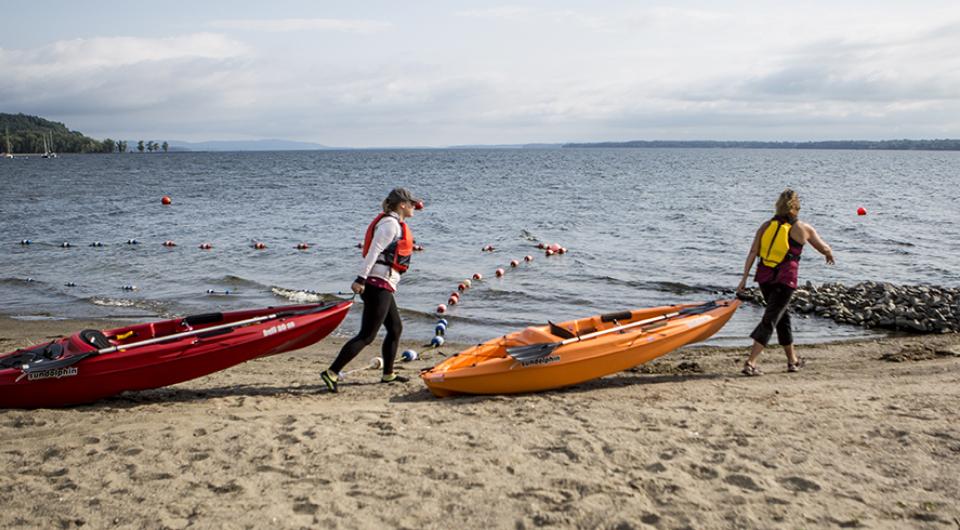 kayakers carting kayaks to water