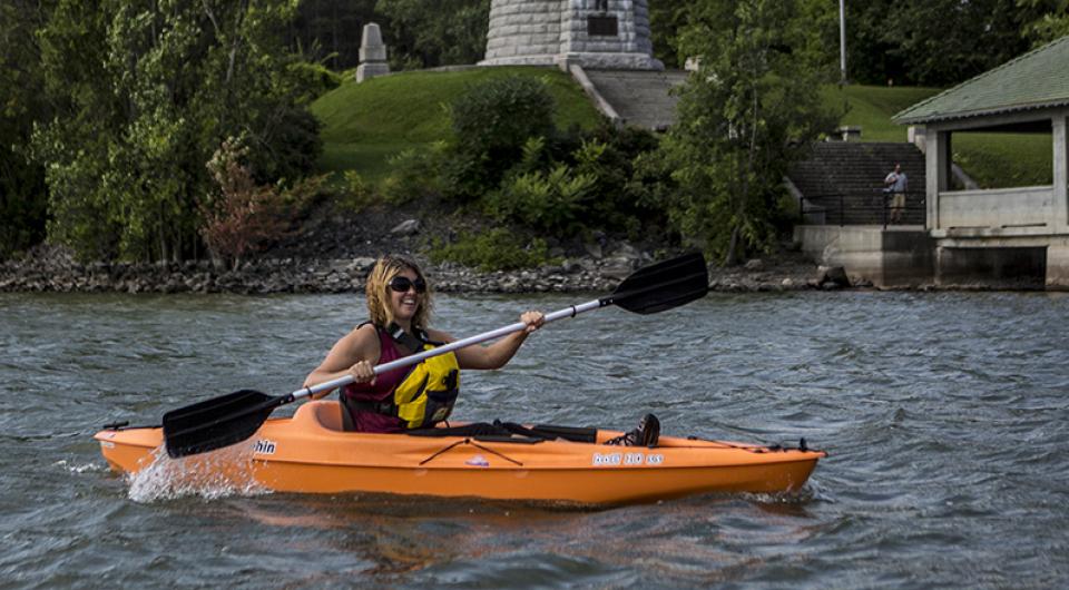 kayaker paddling near lighthouse