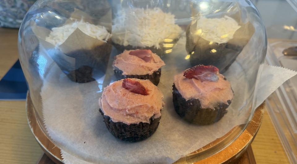 Exterior of the Essex Ice Cream Cafe with dining tables and yellow umbrellas