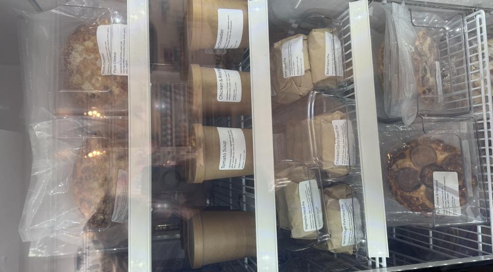 The dining space with freezer section and the stocked front counter at Essex Ice Cream Cafe.