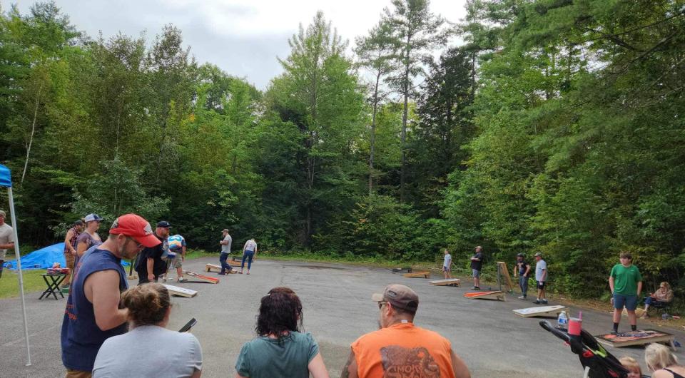 5 teams playing corn hole