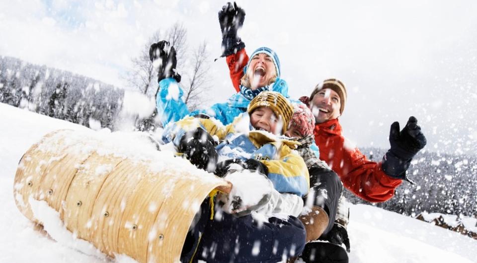 A happy family on a toboggan