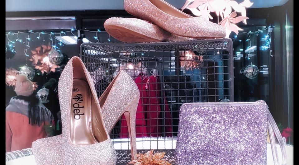 Shoes and purses in a display case.