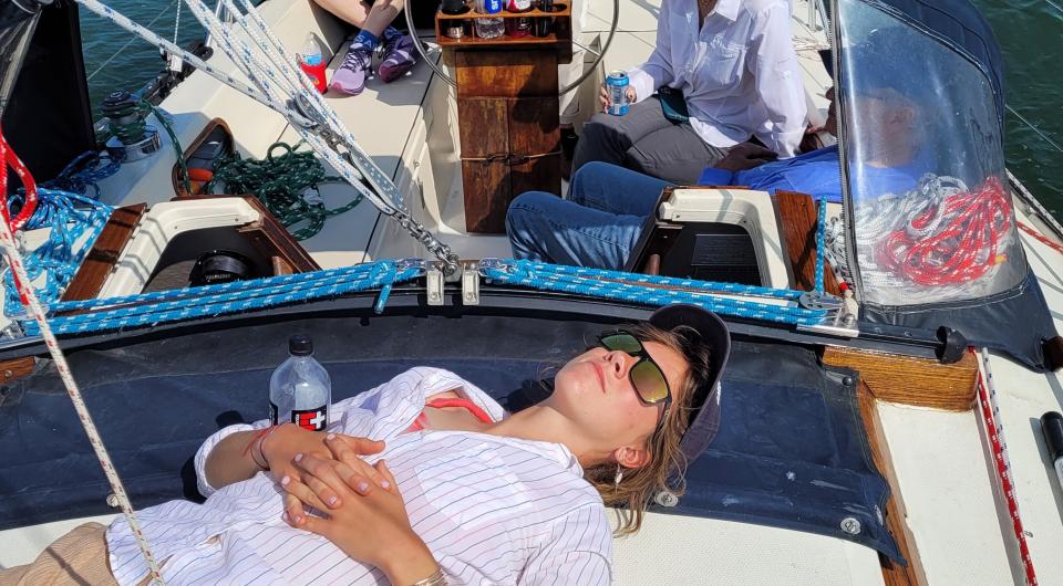 Person relaxing on sailboat