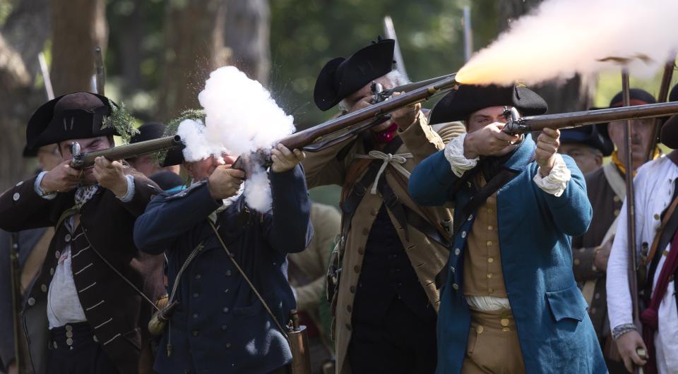 re-enactors firing guns at Fort Ticonderoga