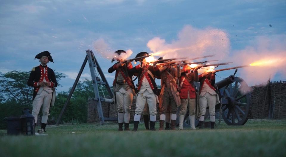 re-enactors firing guns