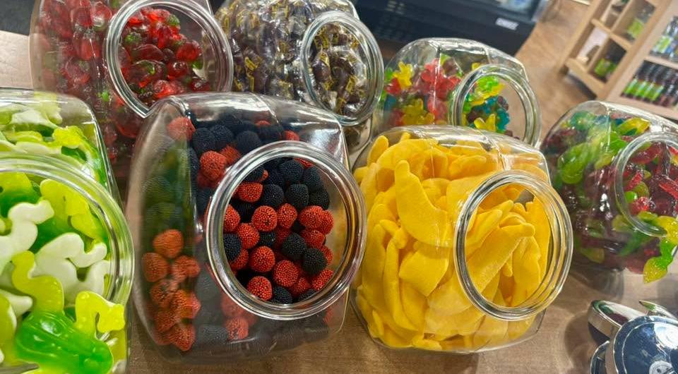 Colorful candies in glass jars at K & D Deli