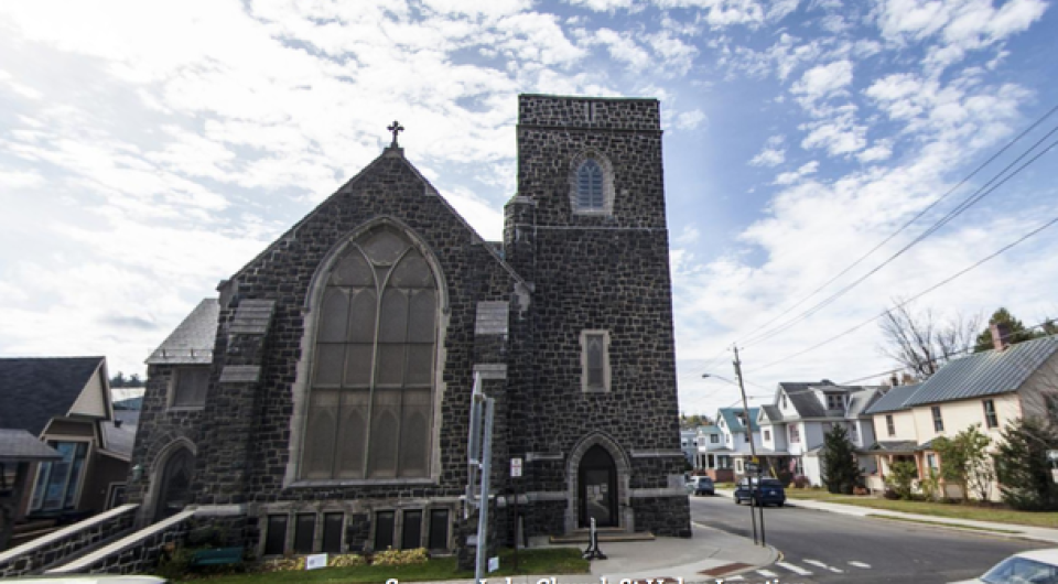 Exterior of the tall grey stone church