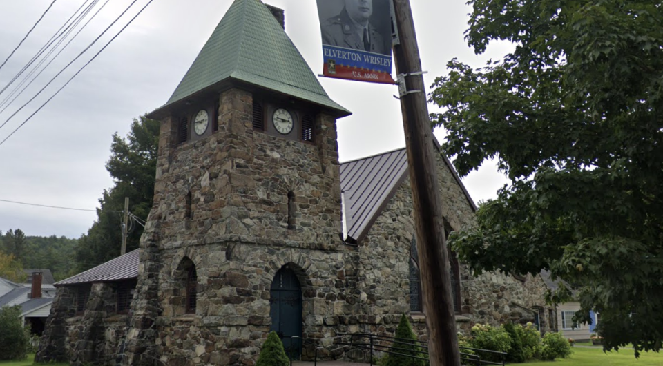 A green patina on the steeple of this stacked river stone church