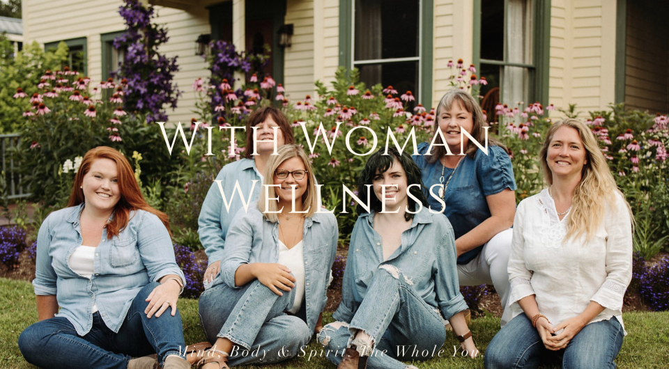 Women in matching outfits smile at the camera